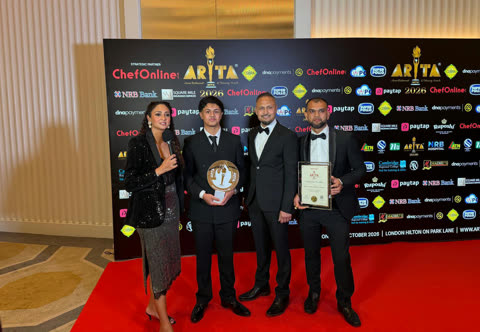 Spice Merchants representatives holding a trophy and certificate during a red-carpet interview at ARTA 2026.